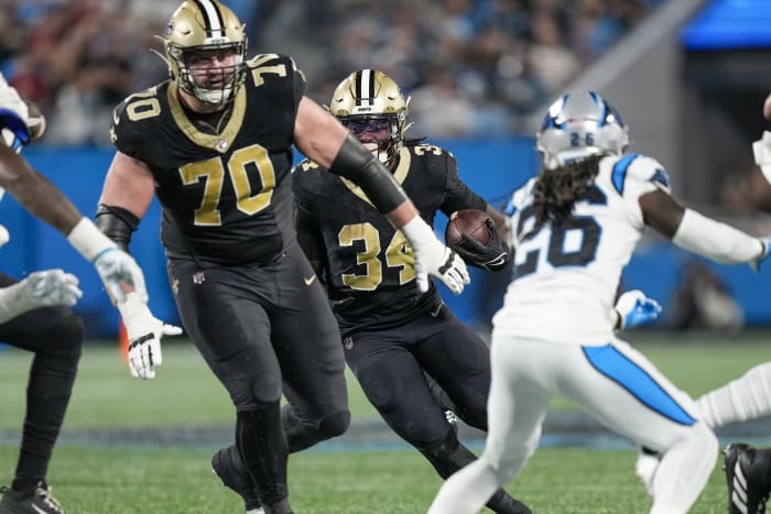Sep 18, 2023; New Orleans Saints running back Tony Jones Jr. (34) follows a block by offensive tackle Trevor Penning (70) against the Carolina Panthers. Mandatory Credit: Jim Dedmon-USA TODAY Sports